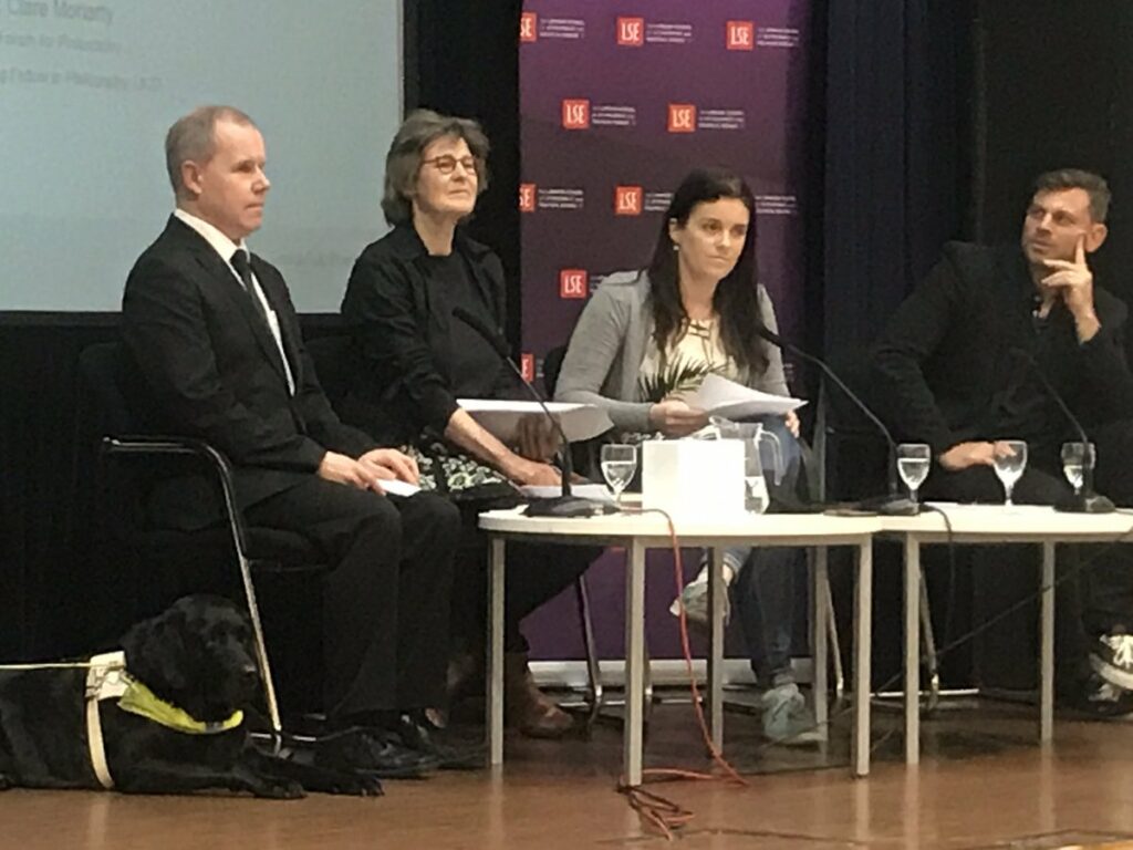 Picture of Barry Ginley and Guide Dog, Marjolein Degenaar, Clare Moriarty and Brian R Glenney on stage at the LSE